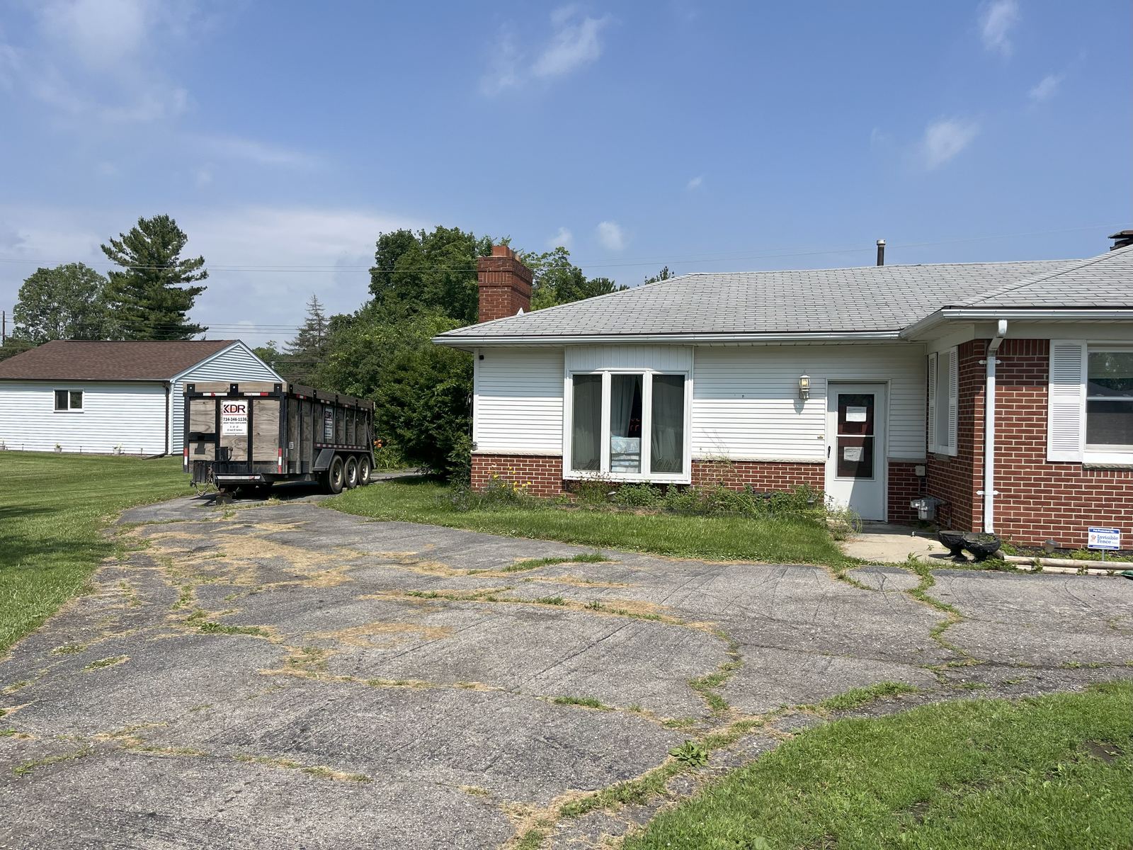 Kincaide dumpster trailer backed up a wide asphalt driveway